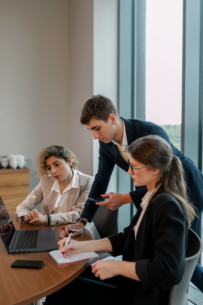 Group of young professionals working together in a modern office setting, focused on business growth.